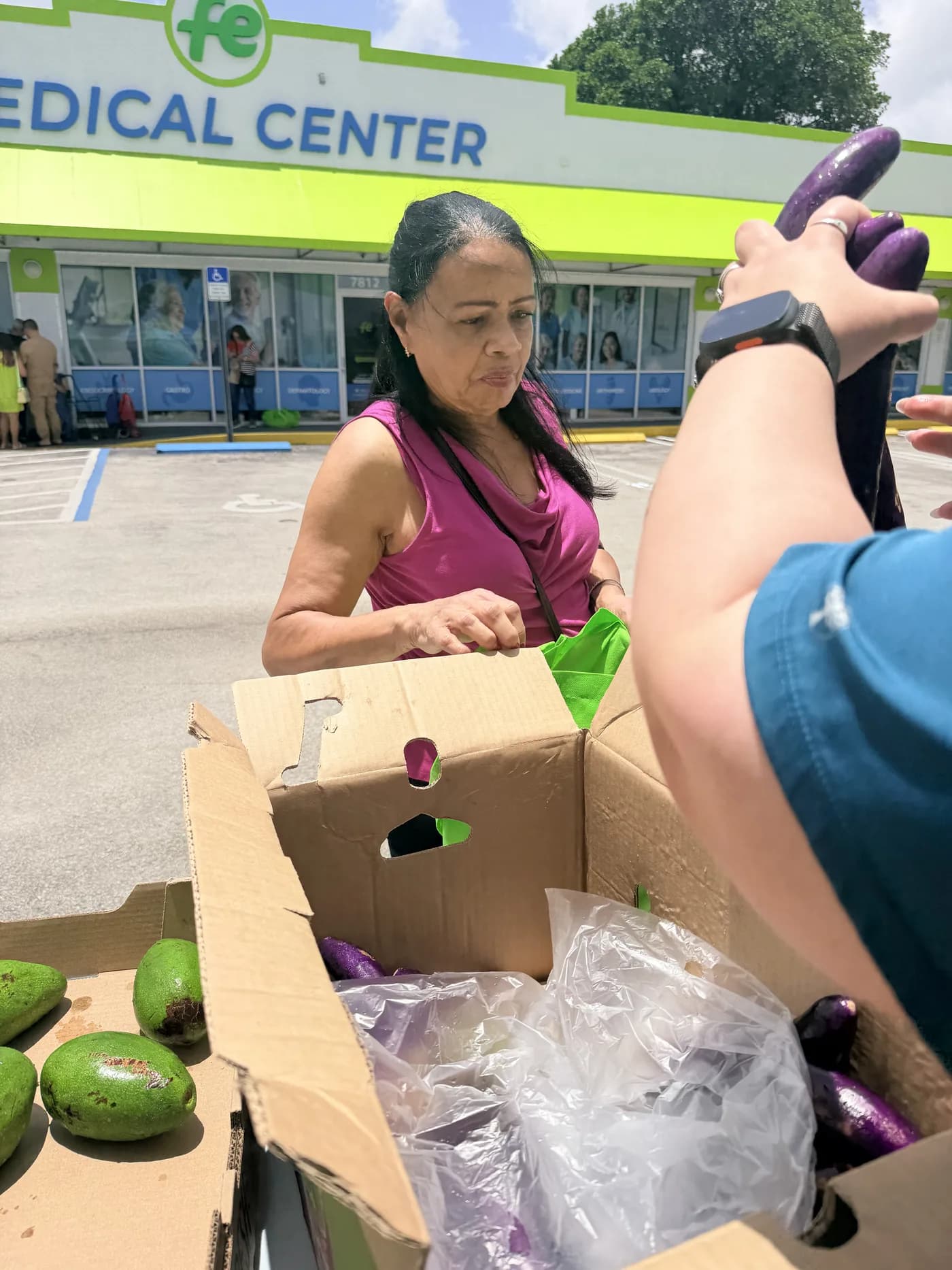 Neighbor picking out fresh produce at a Giving Future Foundation distribution